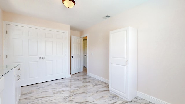 601 SE Karrigan Ter, Port Saint Lucie, FL 34983 - unfurnished bedroom with light marble finish floors and a closet