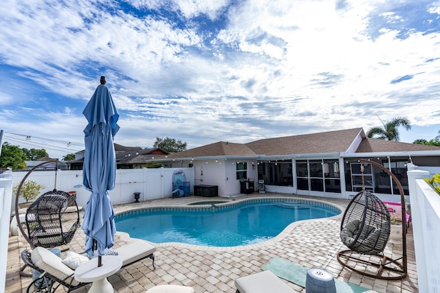 601 SE Karrigan Ter, Port Saint Lucie, FL 34983 - view of pool featuring a sunroom, a fenced backyard, and a patio area