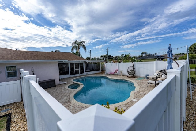 601 SE Karrigan Ter, Port Saint Lucie, FL 34983 - view of swimming pool with a sunroom, a fenced backyard, a patio, and a pool with connected hot tub