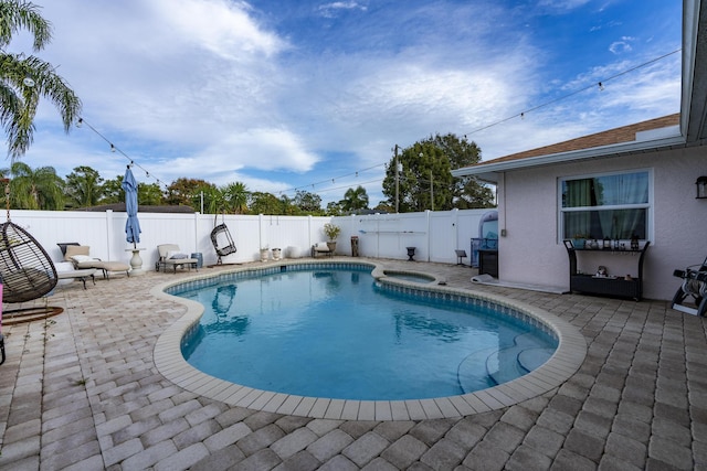 601 SE Karrigan Ter, Port Saint Lucie, FL 34983 - view of pool with a patio, a fenced backyard, and a pool with connected hot tub