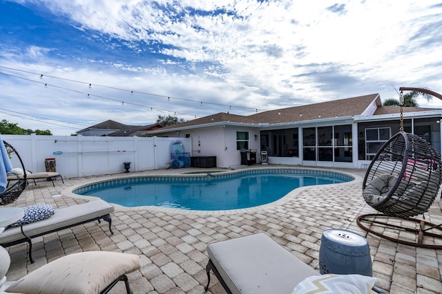 601 SE Karrigan Ter, Port Saint Lucie, FL 34983 - view of swimming pool featuring a sunroom, a patio, and a fenced backyard