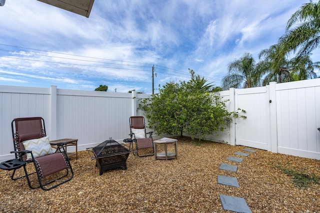 601 SE Karrigan Ter, Port Saint Lucie, FL 34983 - view of yard featuring a gate and an outdoor fire pit