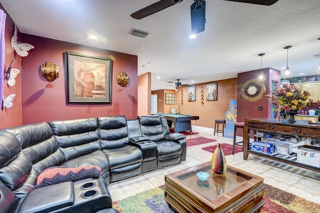 living room featuring ceiling fan, pool table, a textured ceiling, and light tile patterned floors