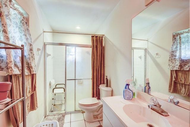 bathroom with tile patterned flooring, vanity, an enclosed shower, and toilet