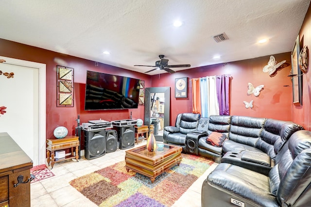 tiled living room with ceiling fan and a textured ceiling