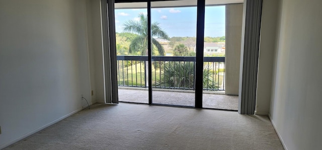 2425 Presidential Way Unit 402, West Palm Beach, FL 33401 - carpeted empty room with healthy amount of natural light and baseboards