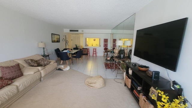 tiled living room featuring a textured ceiling