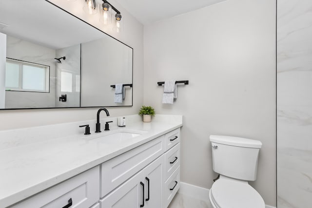 bathroom featuring toilet, vanity, and tiled shower