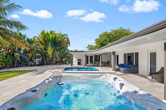 view of pool featuring a patio, ceiling fan, a hot tub, and an outdoor living space