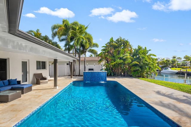 view of pool featuring pool water feature, a patio area, outdoor lounge area, and a water view