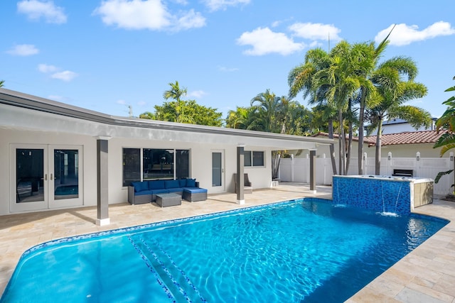 view of pool with a jacuzzi, french doors, pool water feature, and a patio area