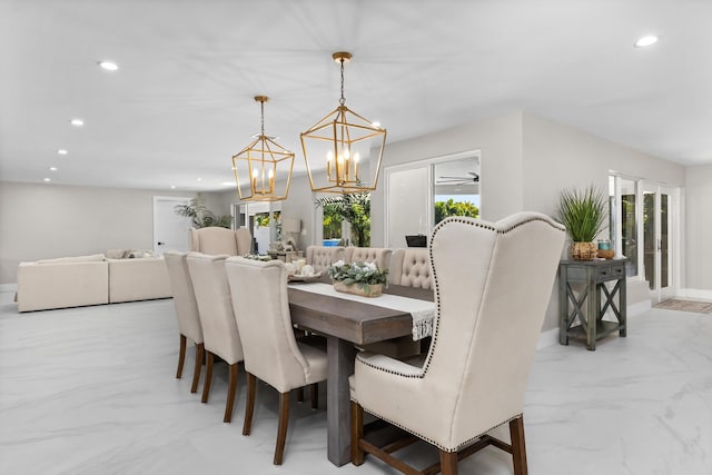 dining room featuring ceiling fan with notable chandelier and a healthy amount of sunlight