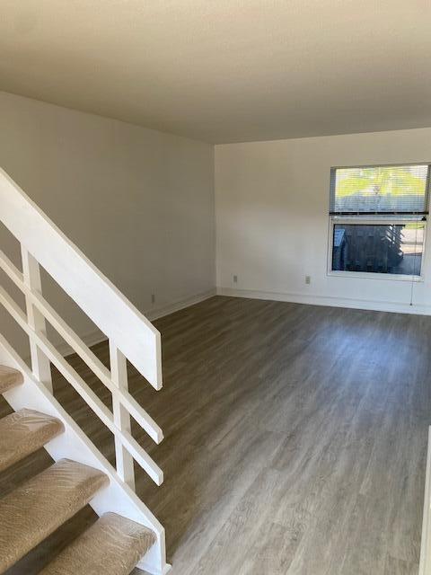 unfurnished living room featuring dark hardwood / wood-style floors