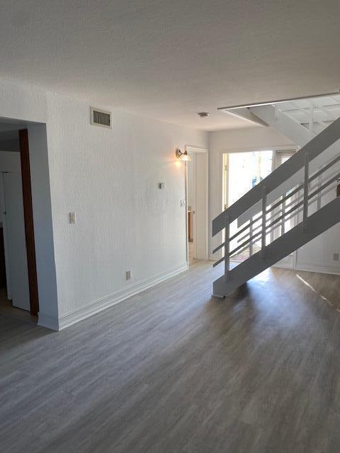 unfurnished living room featuring dark hardwood / wood-style floors