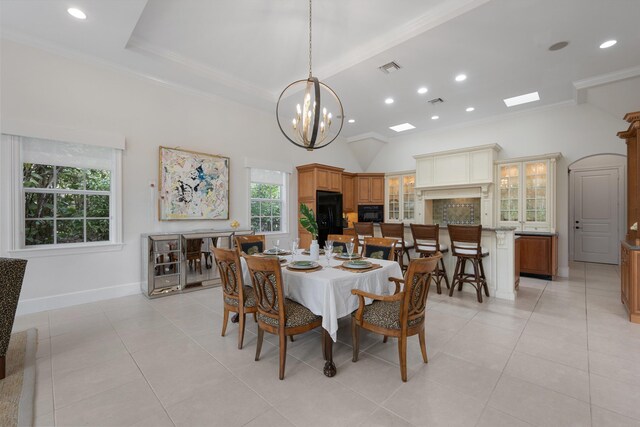 dining room featuring light tile patterned flooring, ornamental molding, and a chandelier