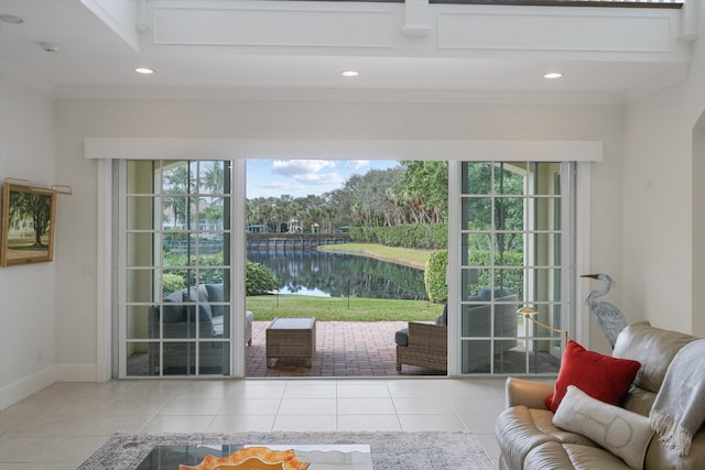 doorway to outside featuring crown molding, a water view, and light tile patterned floors