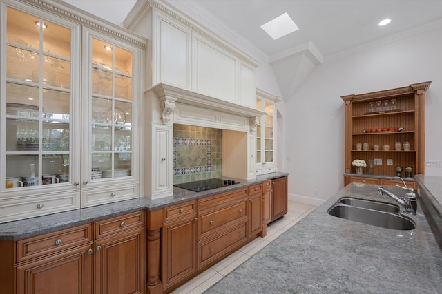 kitchen featuring sink, a skylight, ornamental molding, light tile patterned flooring, and black electric cooktop