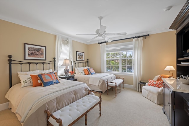 bedroom featuring ornamental molding, light carpet, and ceiling fan