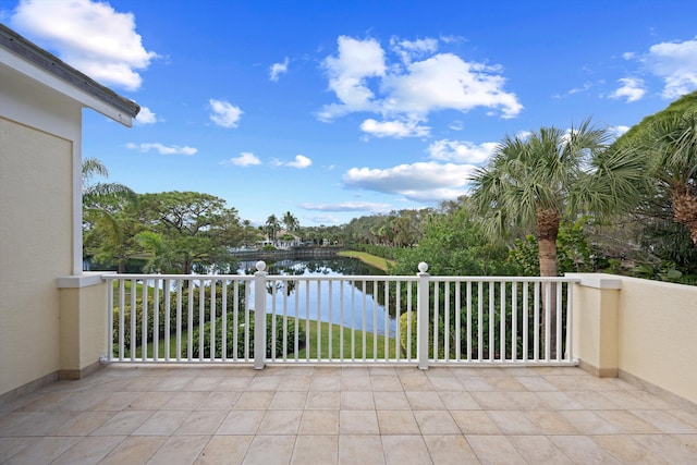 view of patio with a balcony and a water view