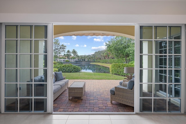 interior space featuring outdoor lounge area and a water view