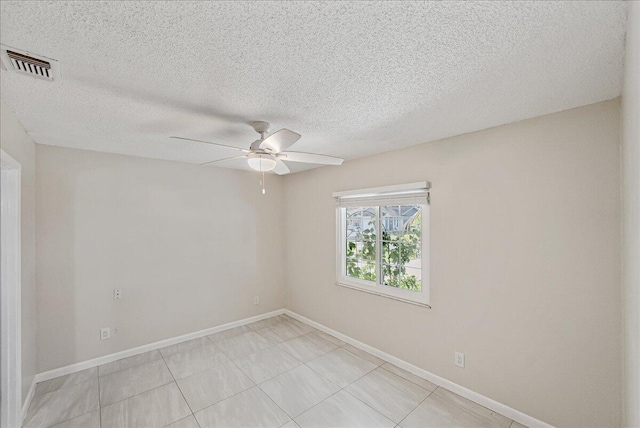 spare room with ceiling fan and a textured ceiling