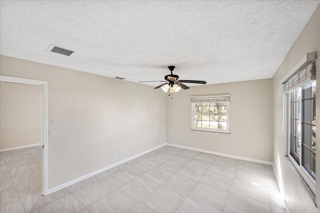 empty room featuring a textured ceiling and ceiling fan