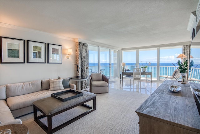 living room featuring a textured ceiling, ornamental molding, expansive windows, and a water view