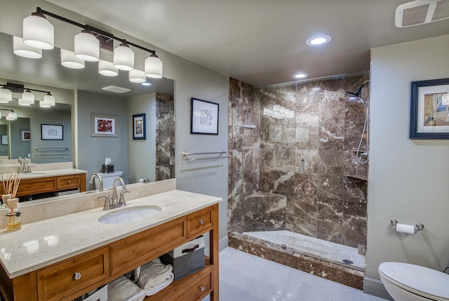 bathroom featuring a tile shower, tile patterned flooring, toilet, and vanity