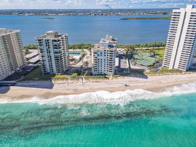 drone / aerial view featuring a water view and a view of the beach