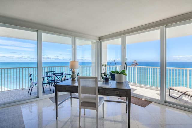 sunroom / solarium featuring plenty of natural light and a water view