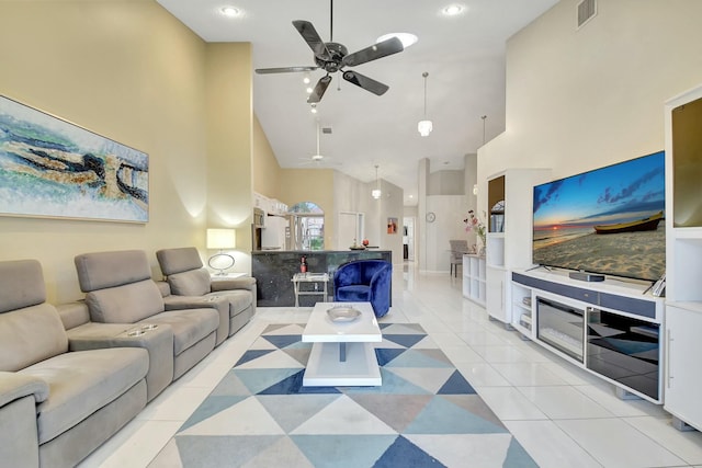 living room with ceiling fan, high vaulted ceiling, and light tile patterned floors