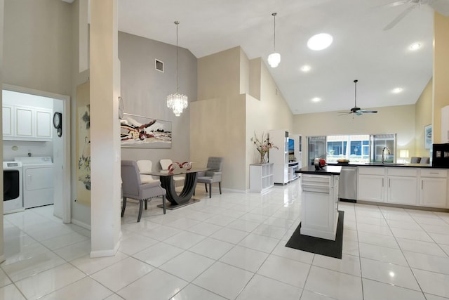 kitchen with white cabinets, dishwasher, a towering ceiling, and sink