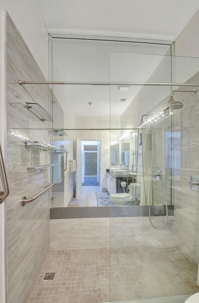 bathroom featuring vanity and a shower with shower door