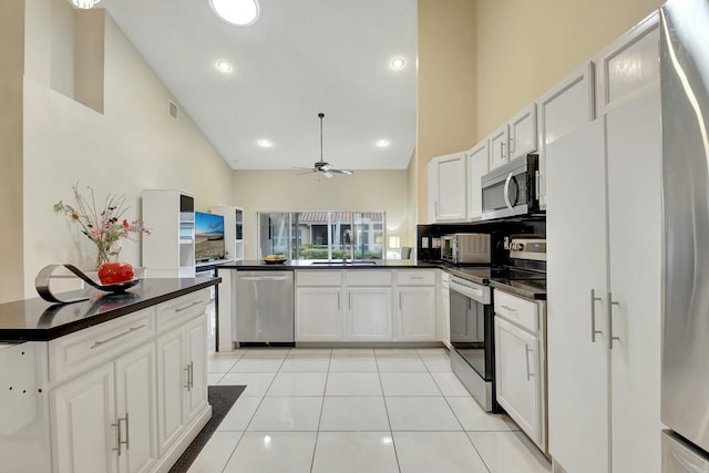 kitchen featuring stainless steel appliances, white cabinetry, high vaulted ceiling, and light tile patterned floors