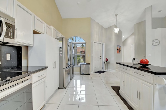 kitchen featuring stainless steel appliances, white cabinetry, an inviting chandelier, lofted ceiling, and hanging light fixtures