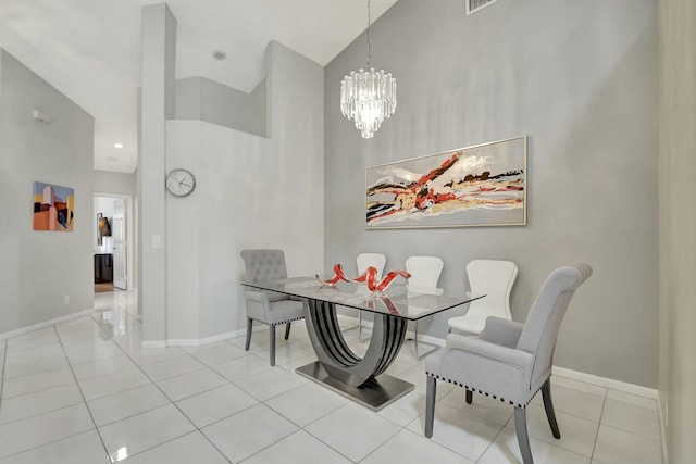 tiled dining area featuring a towering ceiling and a chandelier