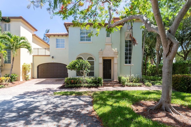 mediterranean / spanish-style home with a garage