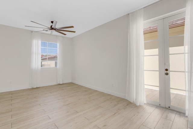 unfurnished room with light hardwood / wood-style floors, ceiling fan, and french doors