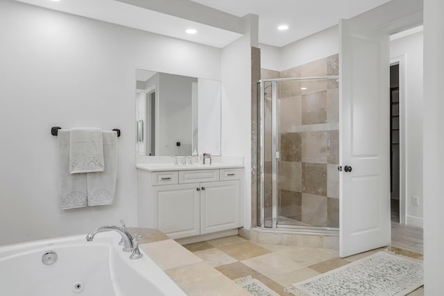 bathroom featuring vanity and shower with separate bathtub