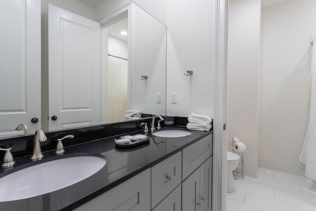 bathroom with tile patterned floors, vanity, and toilet