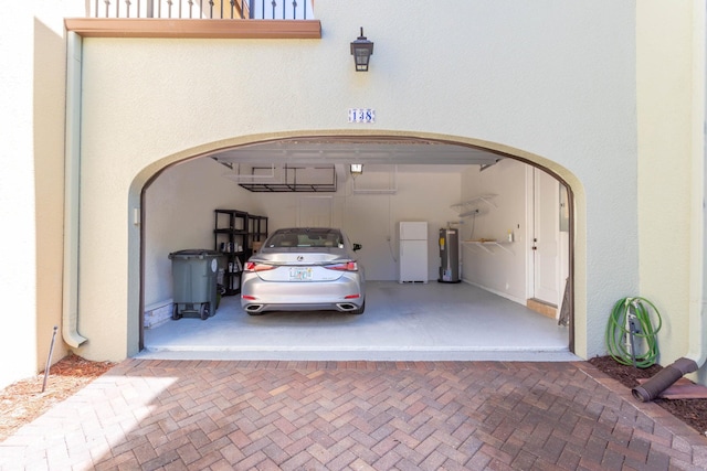 garage with white fridge and water heater