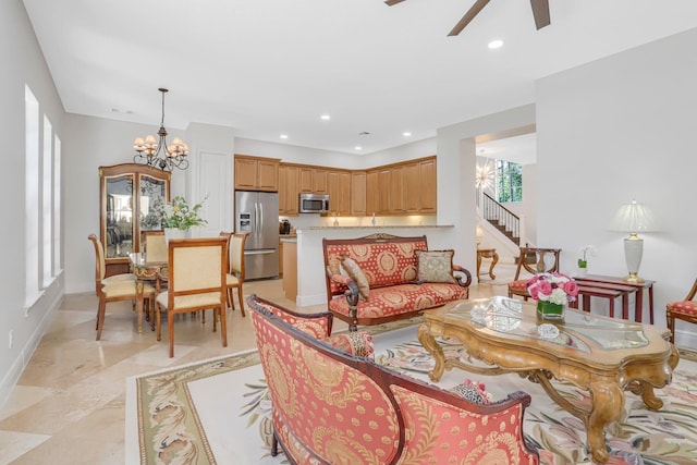 dining area featuring ceiling fan with notable chandelier