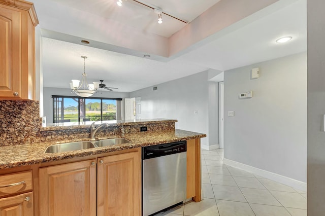 kitchen featuring stainless steel dishwasher, light tile patterned floors, backsplash, ceiling fan with notable chandelier, and sink