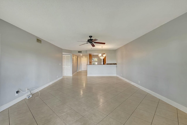 tiled spare room featuring ceiling fan