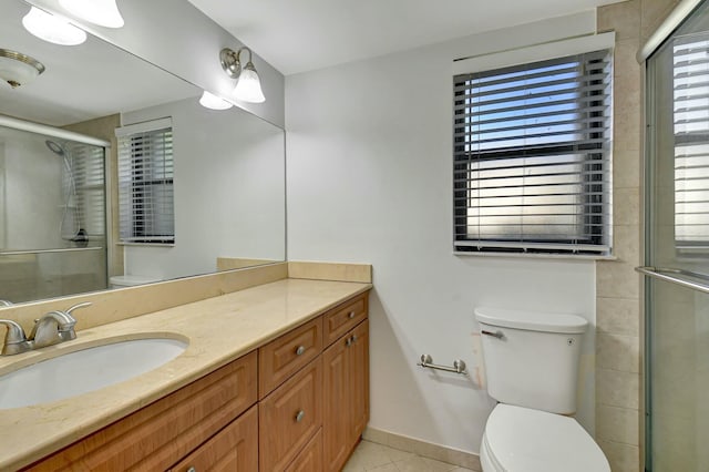 bathroom featuring a healthy amount of sunlight, vanity, tile patterned flooring, and a shower with shower door