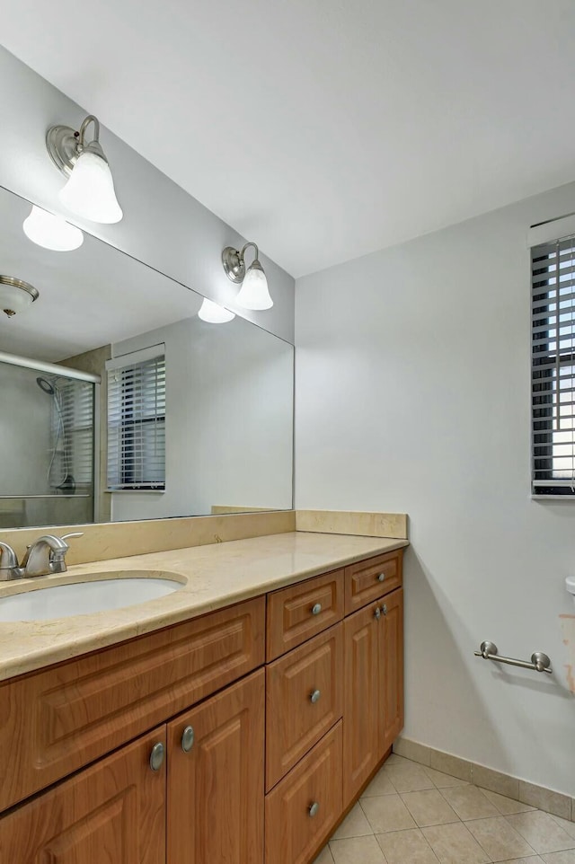 bathroom featuring vanity, tile patterned floors, and walk in shower