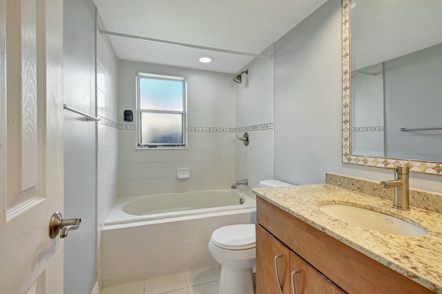 full bathroom with toilet, tiled shower / bath, tile patterned floors, and vanity