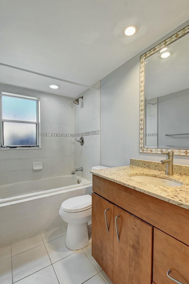 full bathroom with toilet, vanity, tile patterned floors, and tiled shower / bath