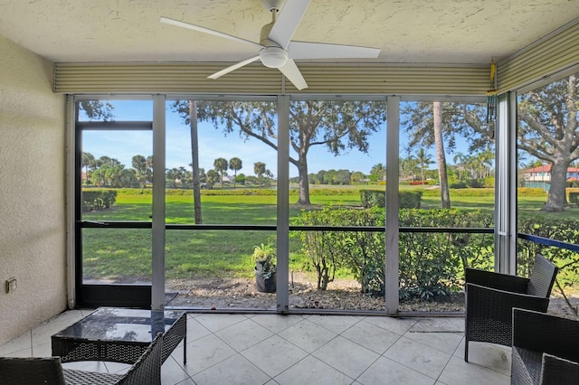 sunroom featuring ceiling fan and a healthy amount of sunlight