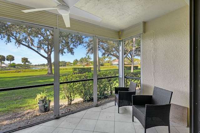 sunroom with a rural view and ceiling fan